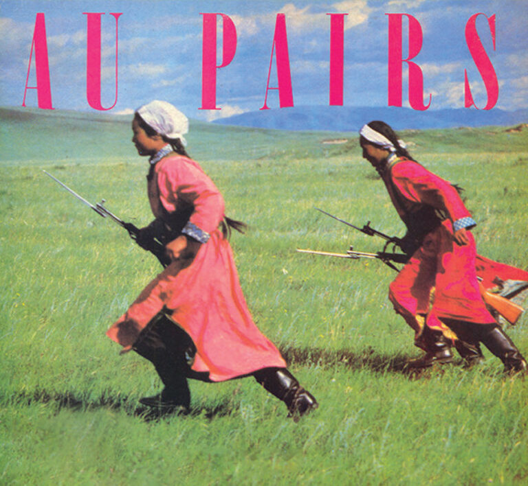 An illustration of two women in headscarves and traditional dress running in a field carrying guns with bayonets, with the words Au Pairs written.