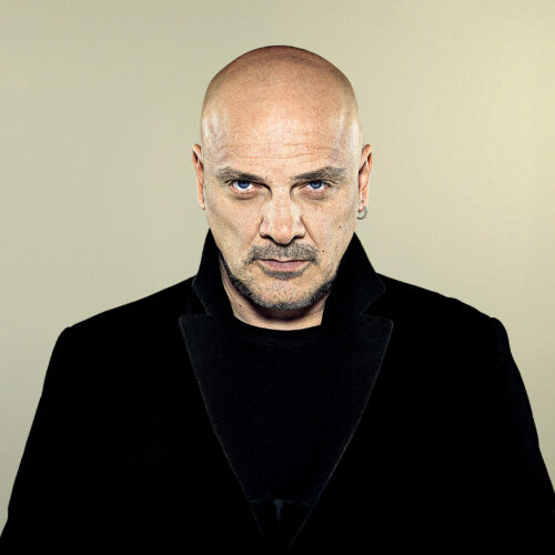 Baz Warne wearing all black looking straight into the camera.